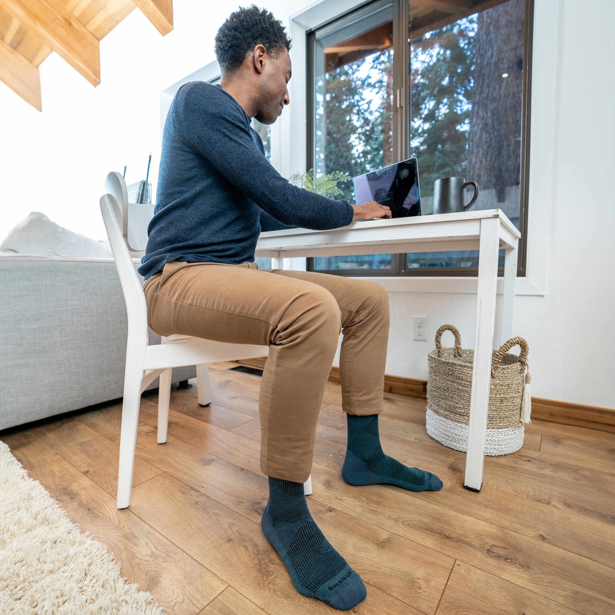 Man zittend met compressiekousen