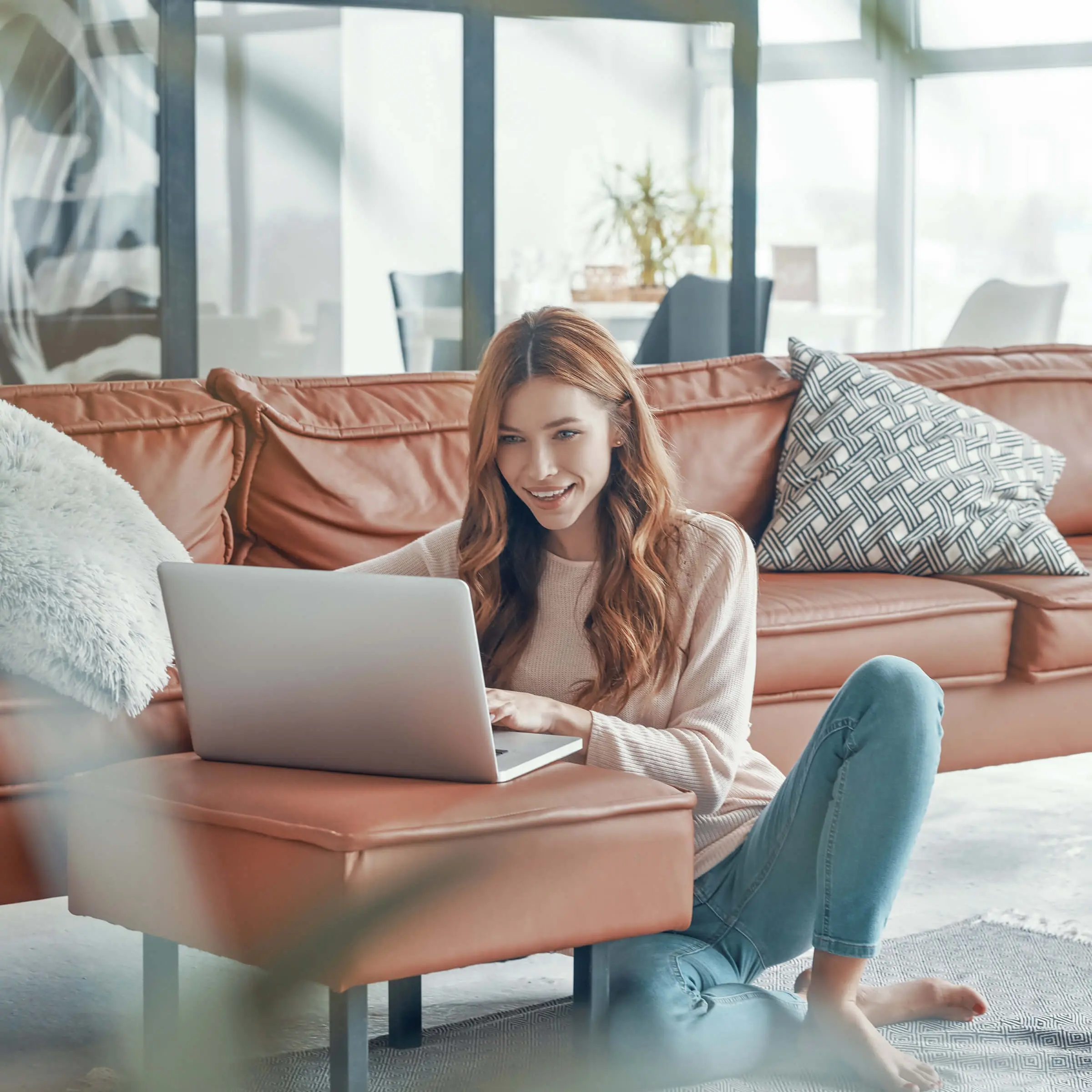 attractive-young-woman-working-laptop-smiling-while-spending-time-home