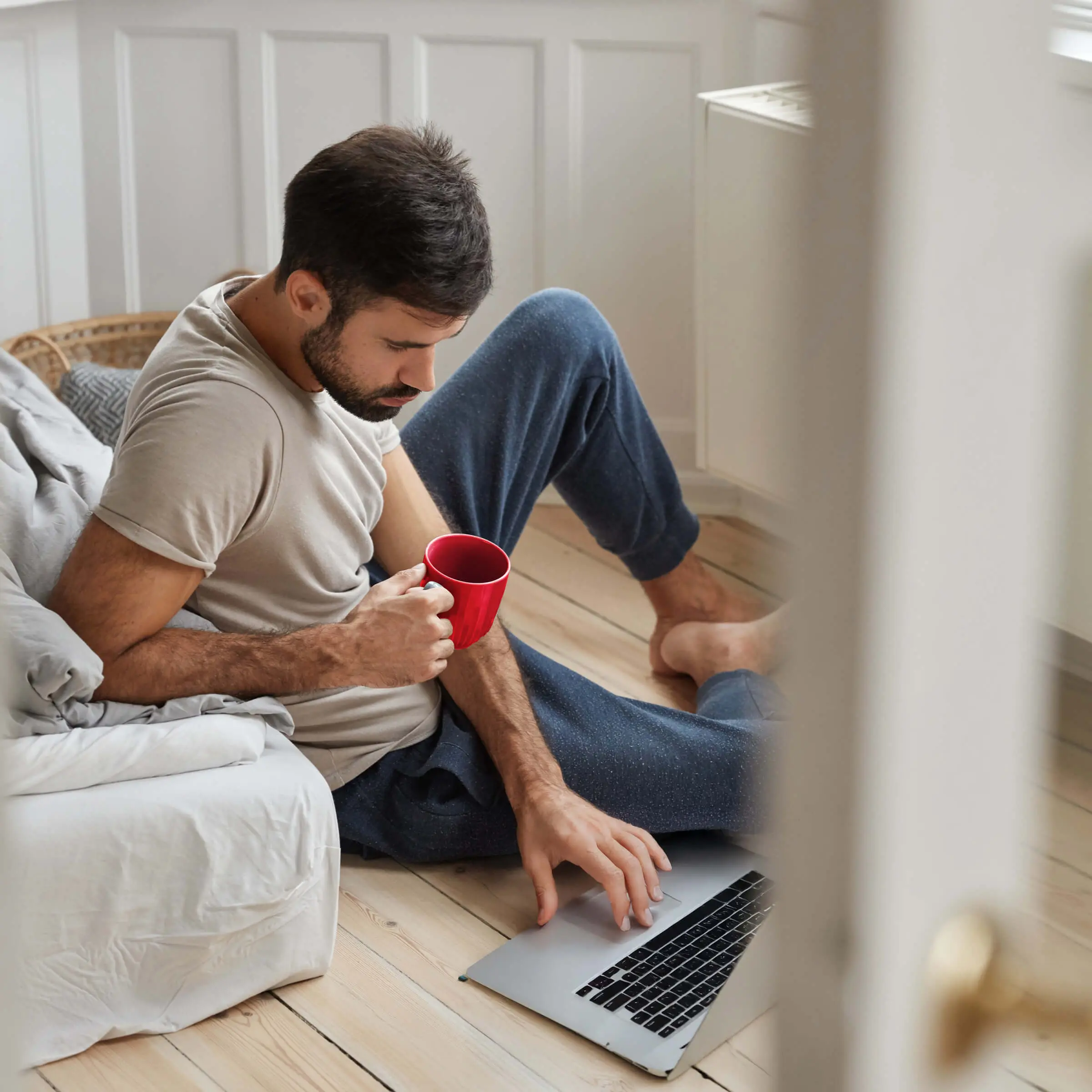 photo-handsome-guy-relaxes-with-literature-enjoy-relax-home-concentrated-reading-sits-floor-holds-cup